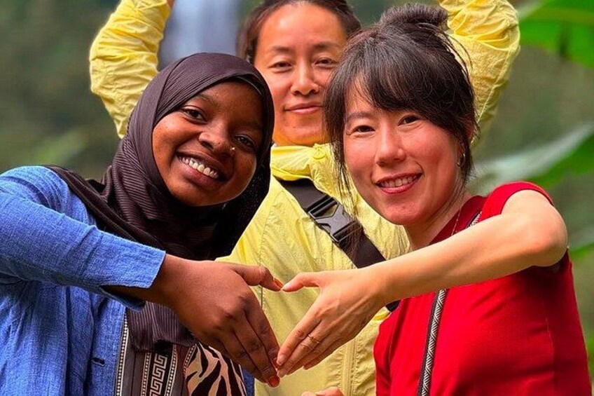 Three people making a heart shape with their hands. 1