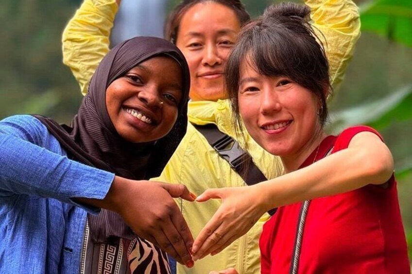Three people making a heart shape with their hands. 1