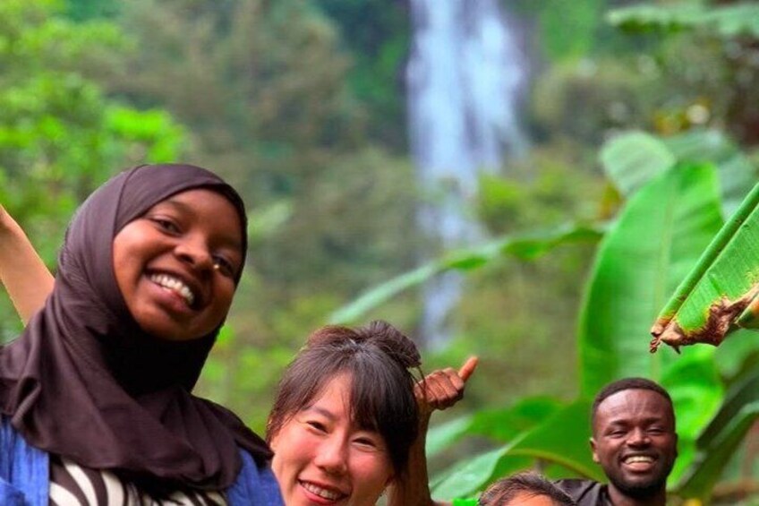 A waterfall in a lush green forest. 2