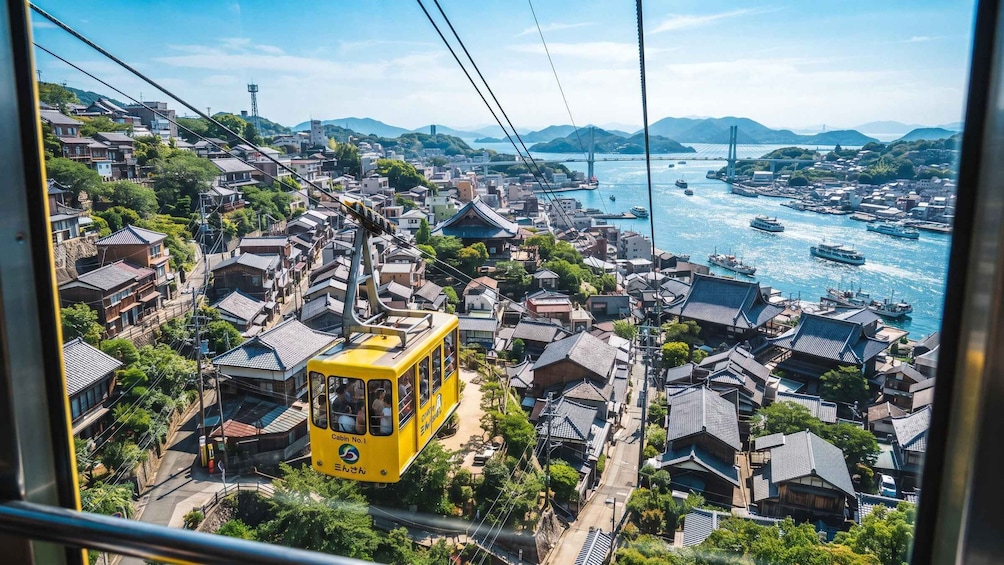 A yellow cable car moving through a densely packed urban area with traditional buildings and a body of water with boats. 1