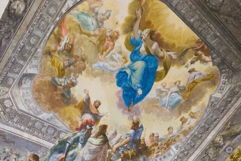 A fresco with a central figure in blue, surrounded by other figures in various poses, set against a golden background. 4
