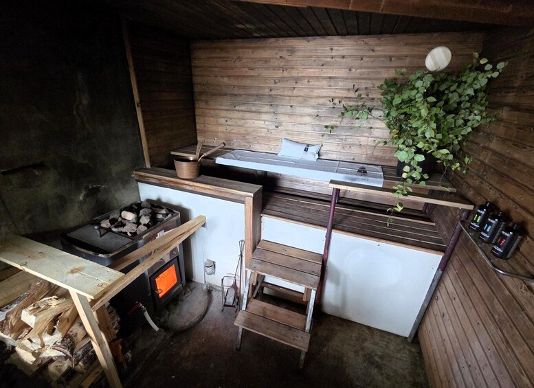 A rustic kitchen with a wood stove, a sink, and a bench. 4