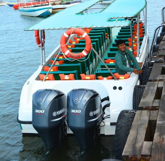 A boat with two Yamaha 300 outboard motors, a life preserver, and a person in a green shirt. 4
