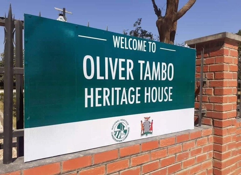 A sign for Oliver Tambo Heritage House with a green background and white text. 1
