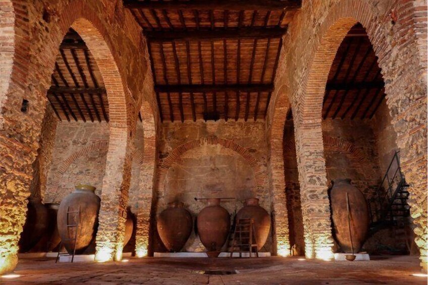 A stone archway with large ceramic pots. 3