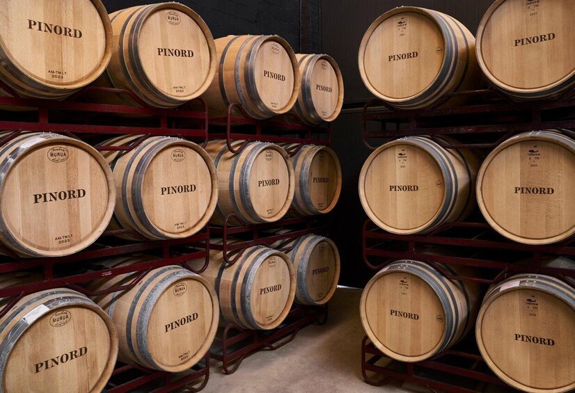 Wooden barrels stacked on shelves. 2