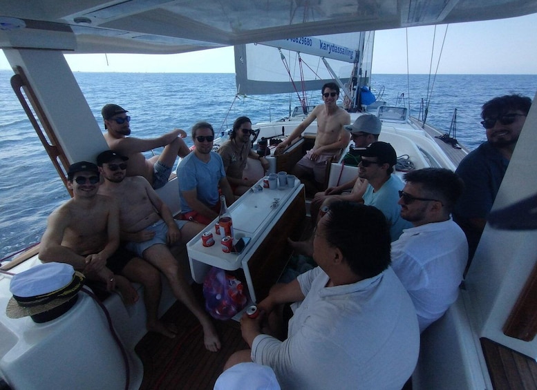 A group of people on a sailboat with a clear view of the ocean. 2