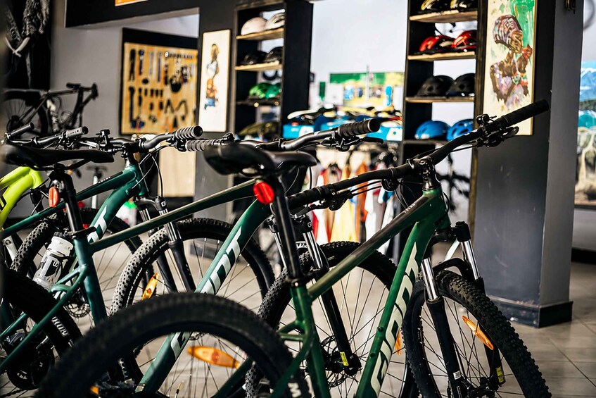 A bicycle shop with various bikes and helmets on display. 1