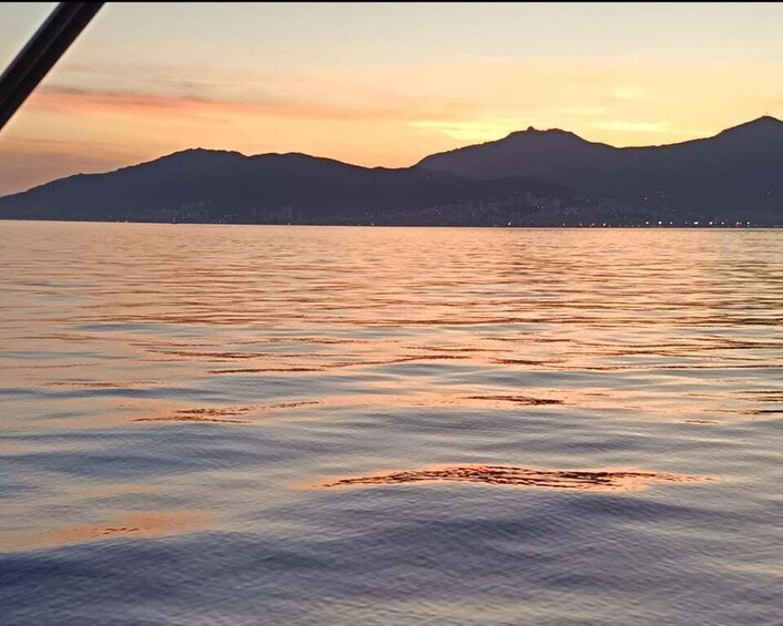 A calm lake with mountains in the background during sunset. 5