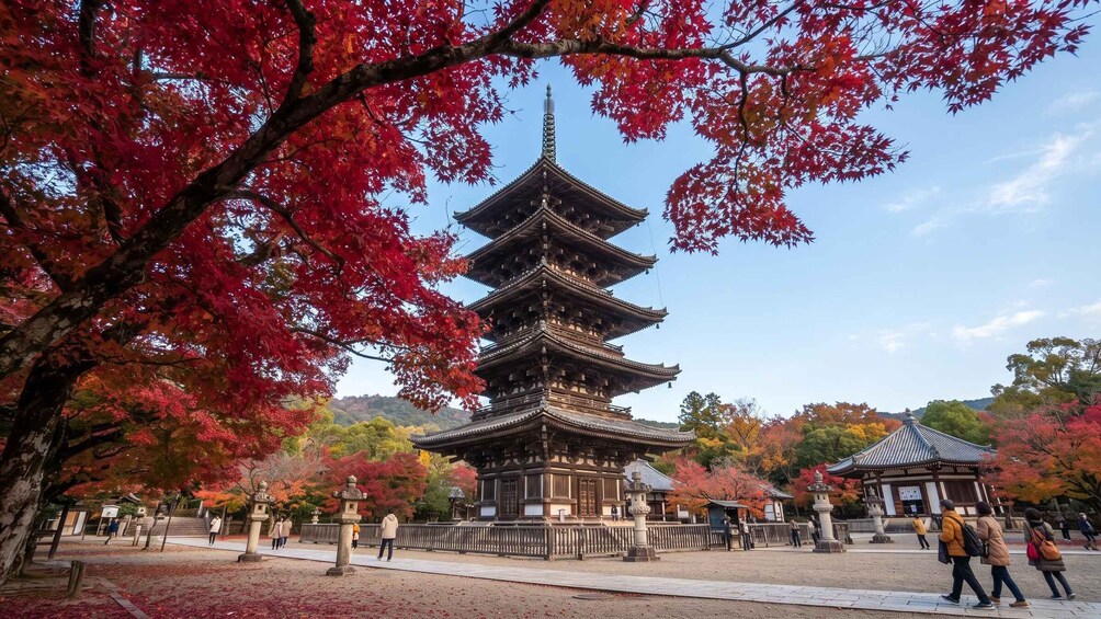 A traditional Japanese pagoda surrounded by autumn foliage. 5