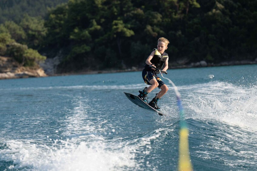 A person wakeboarding on a body of water with waves. 2