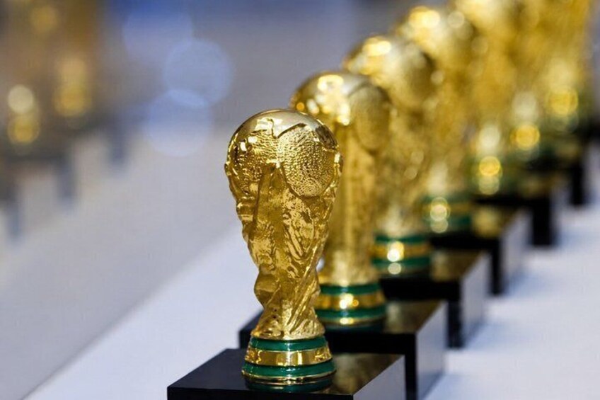 A row of golden trophies on black pedestals. 5