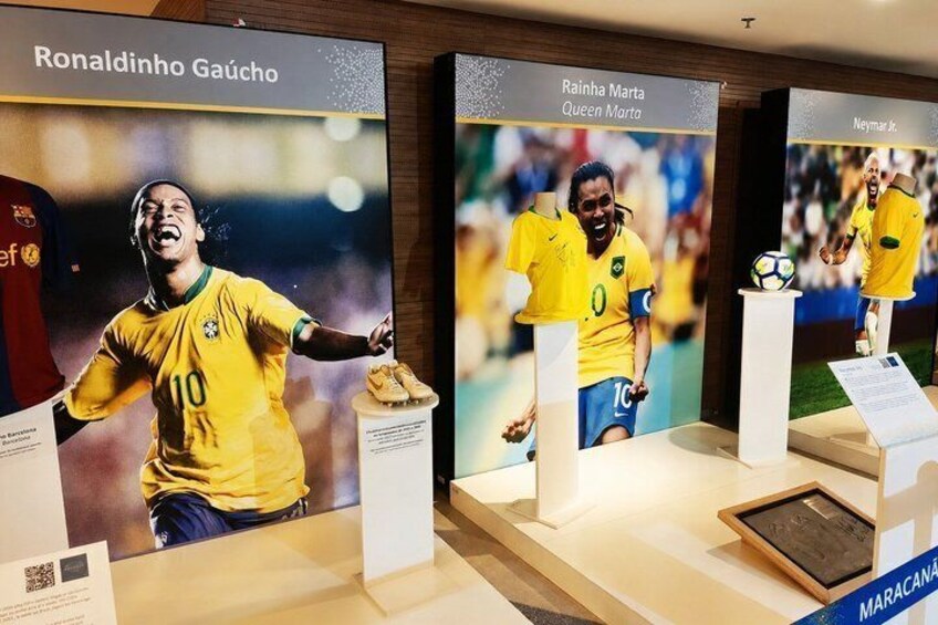 A display with football memorabilia, including jerseys and trophies. 4