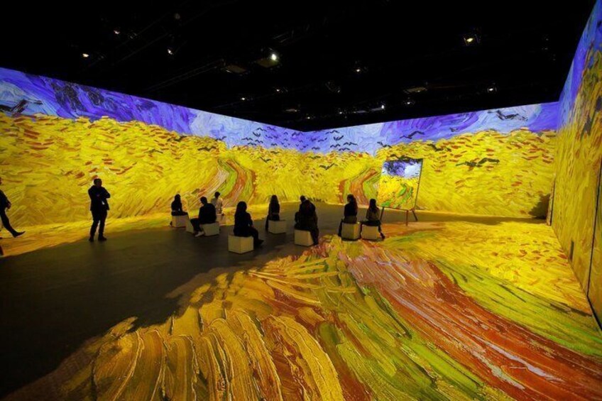 An art exhibition with a large canvas and a digital display. 5