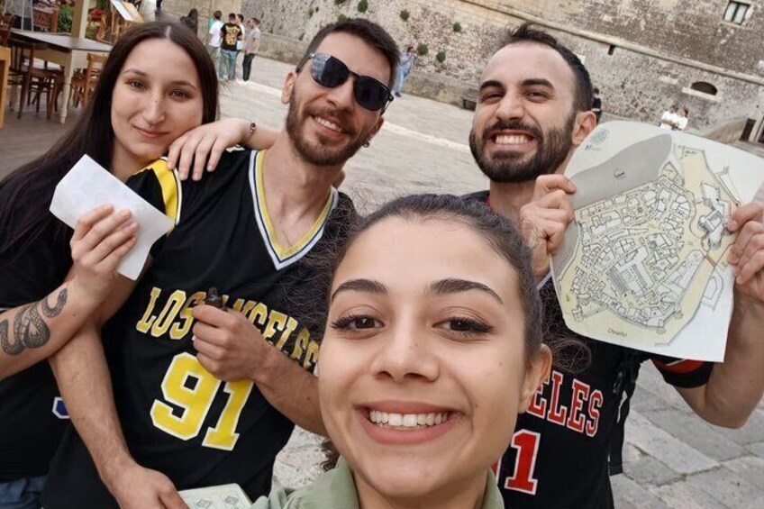 A group of people wearing Los Angeles Clippers jerseys, holding a map. 3