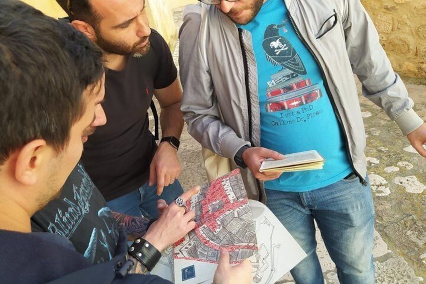Three people examining a map outdoors. 4