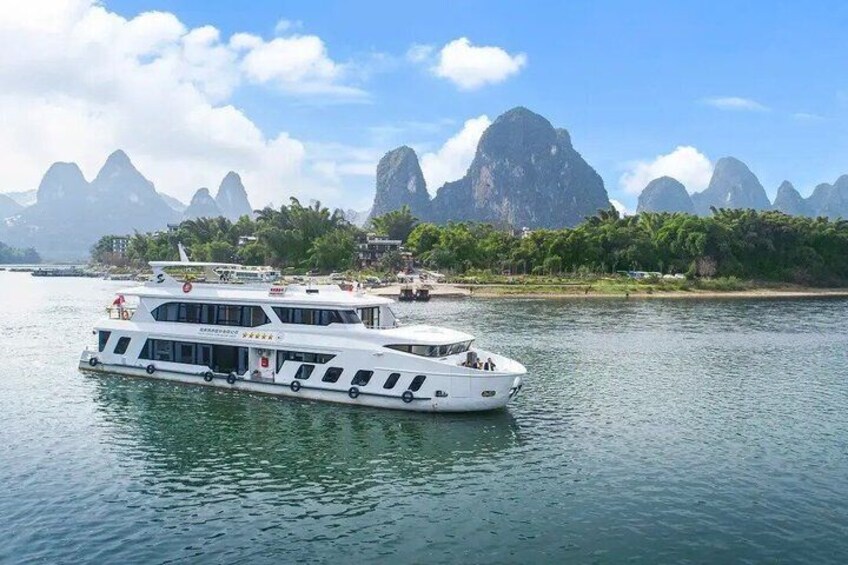 A white boat on calm water with mountains in the background. 1