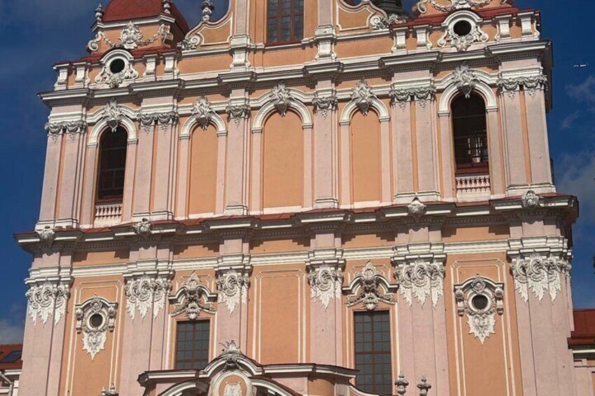 A multi-tiered building with ornate architectural details and a clear blue sky in the background. 5