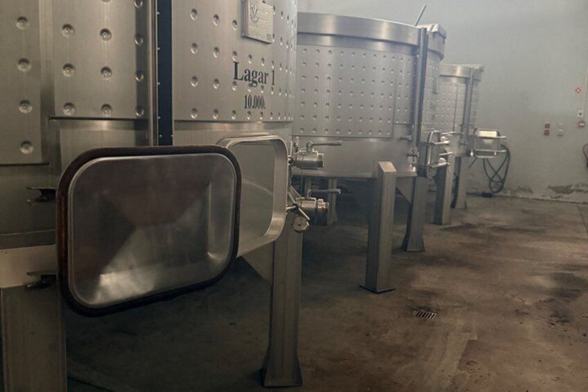 Stainless steel industrial equipment, including tanks and piping, in a clean, organized facility. 3