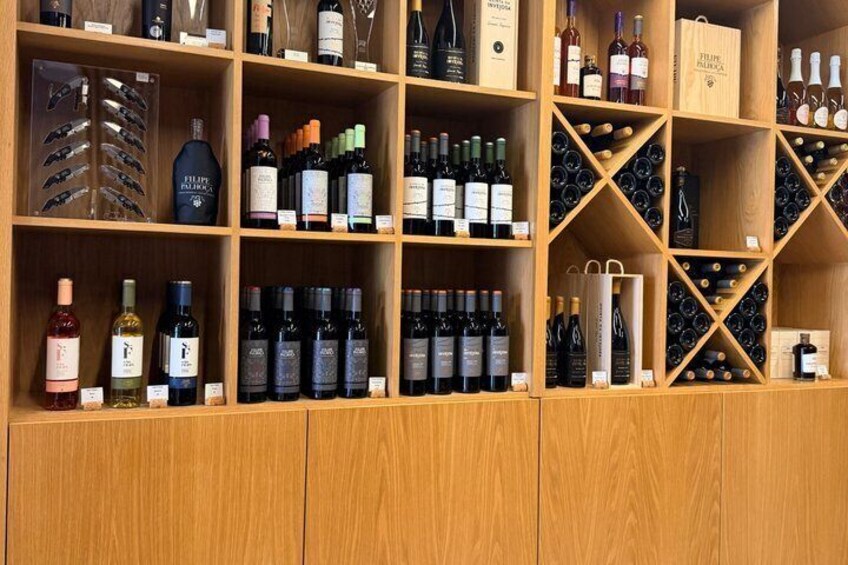 A wooden wine rack with various bottles of wine. 2