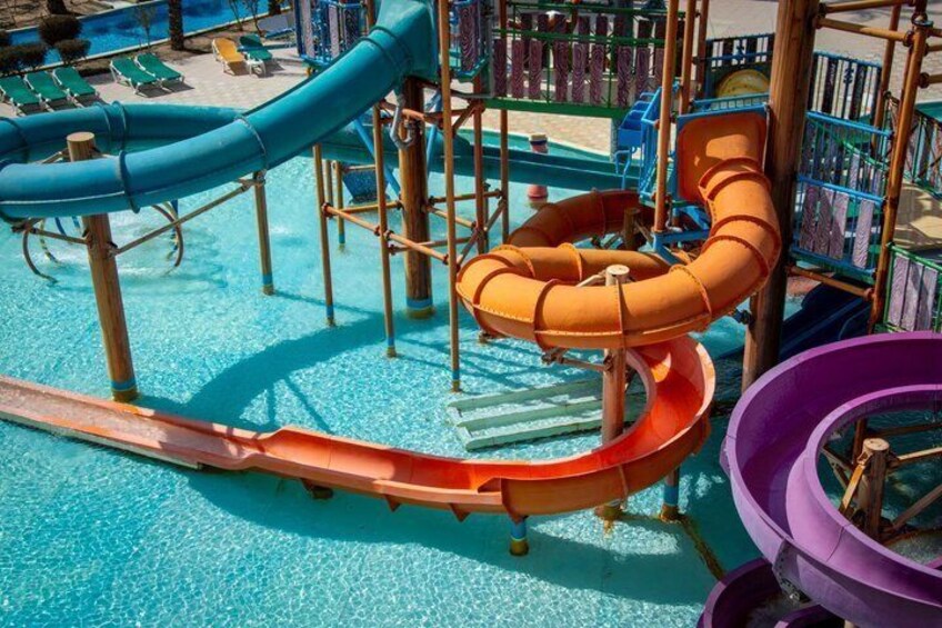 A water park with multiple slides and a pool. 4