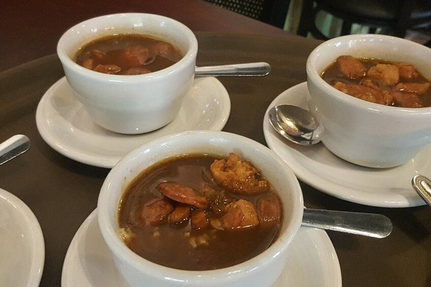 Three bowls of soup on a table. 4