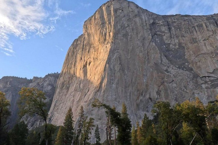 A large mountain with a prominent peak, surrounded by trees. 5