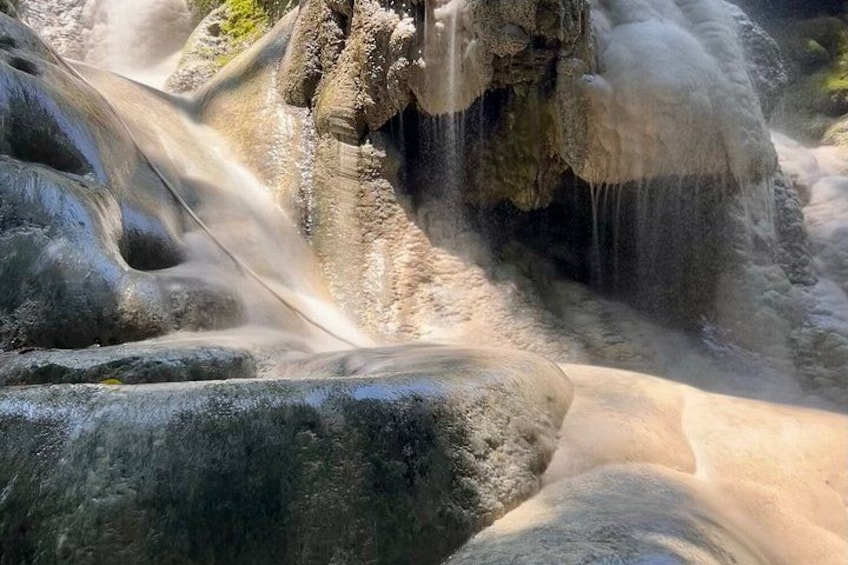 A waterfall cascading over rocks. 3