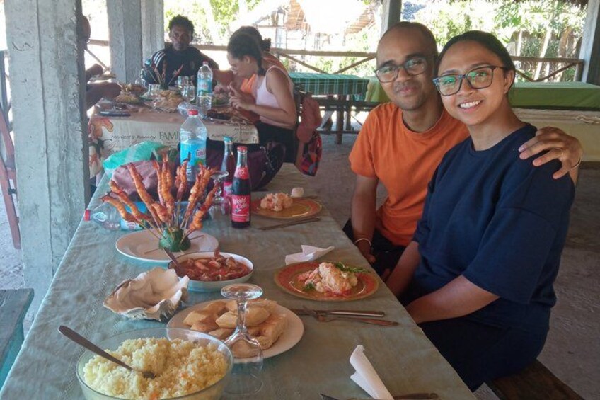 A dining table with various dishes, a bottle of Coca-Cola, and a bottle of water. 4