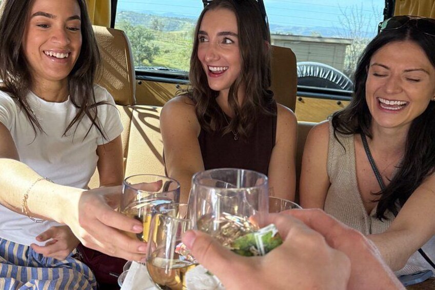 Three people sitting at a table with drinks, outdoors. 4