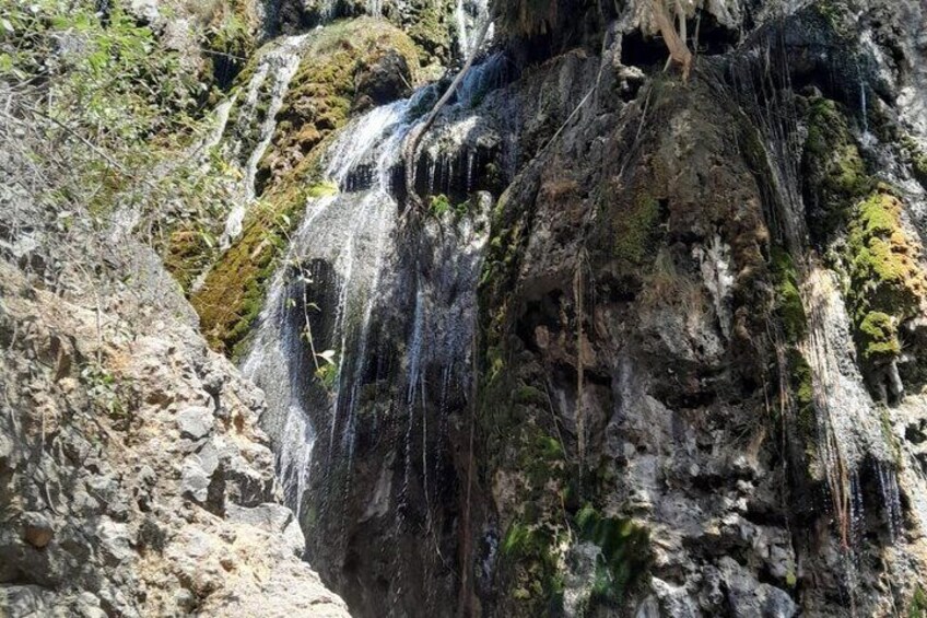 A waterfall cascading down a rocky cliff. 3