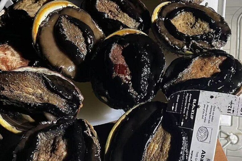 A variety of stuffed mushrooms with labels and price tags. 2