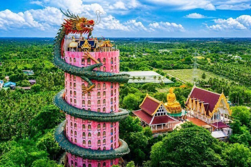 A multi-tiered pink tower with a dragon, surrounded by lush greenery and traditional architecture. 1