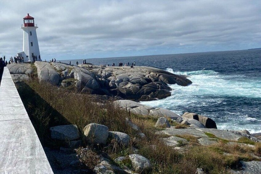 A lighthouse, rocky coastline, and the ocean. 1