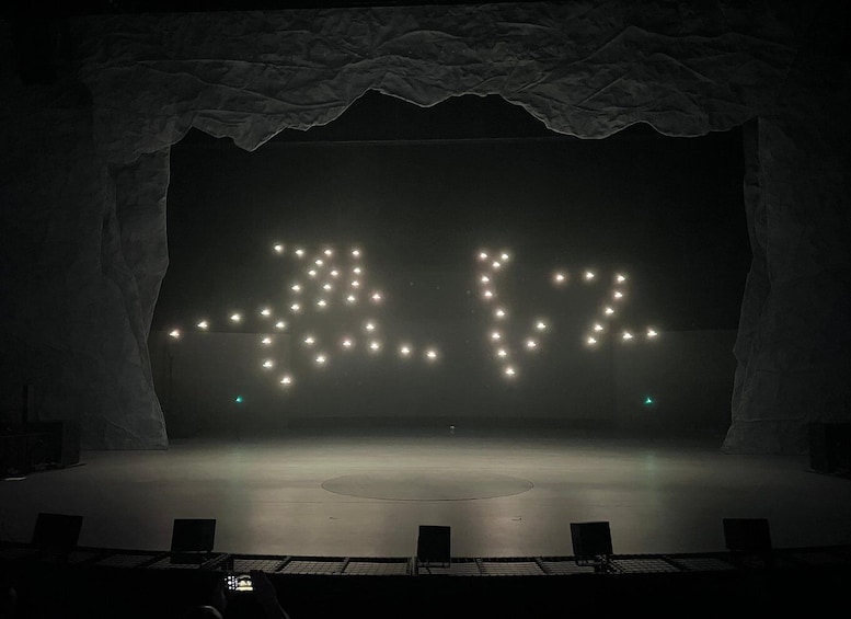 A stage with a backdrop of lights forming the numbers '4 2 1 2'. 2
