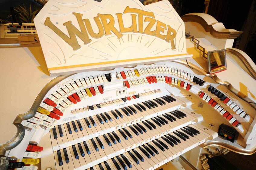 A Wurlitzer organ with multiple keyboards and a variety of colored buttons. 3