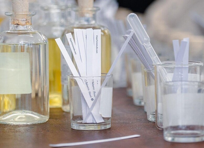 Laboratory glassware, including beakers and test tubes, with labels and a corked bottle. 2
