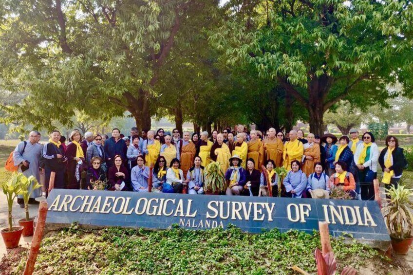 A group of people posing in front of a banner that reads 'Archaeological Survey of India, Nalanda.' 4