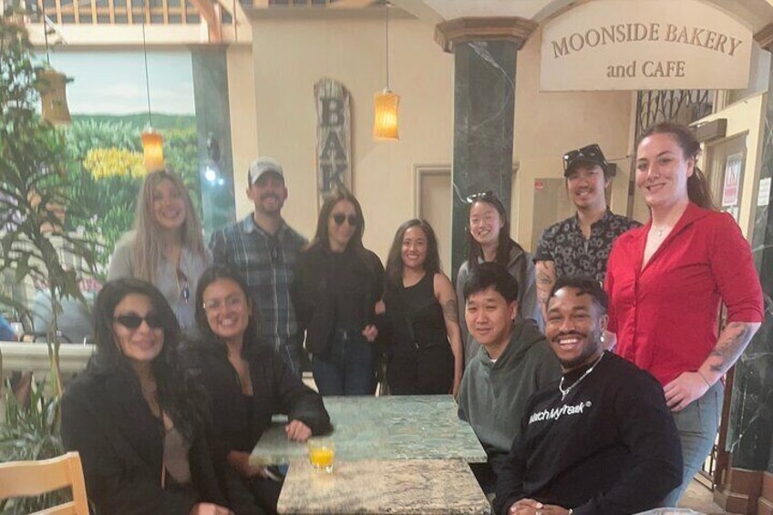 A group of people at a restaurant named Moonside Bakery and Cafe. 4