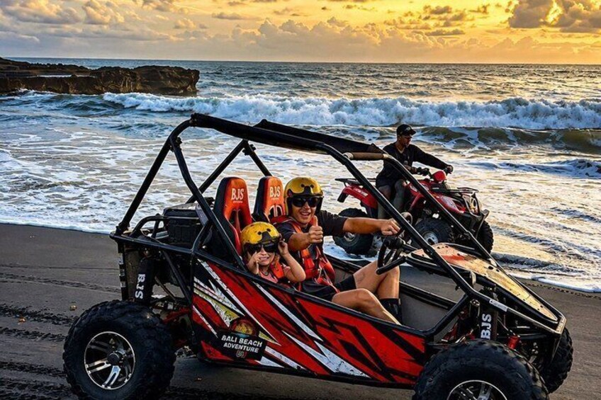 A dune buggy on a beach with waves in the background. 2