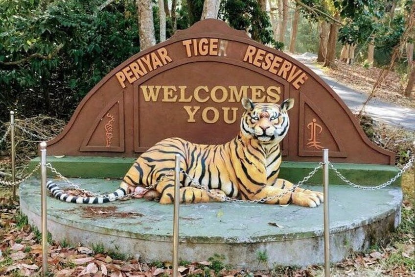 A sign with a tiger and the text 'Periyar Tiger Reserve Welcomes You'. 2