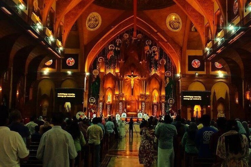 A church interior with an altar, pews, and a congregation. 4
