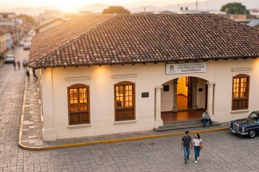 A building with a tiled roof and a sign reading 'Centro Cultural Sampeprano.' 4