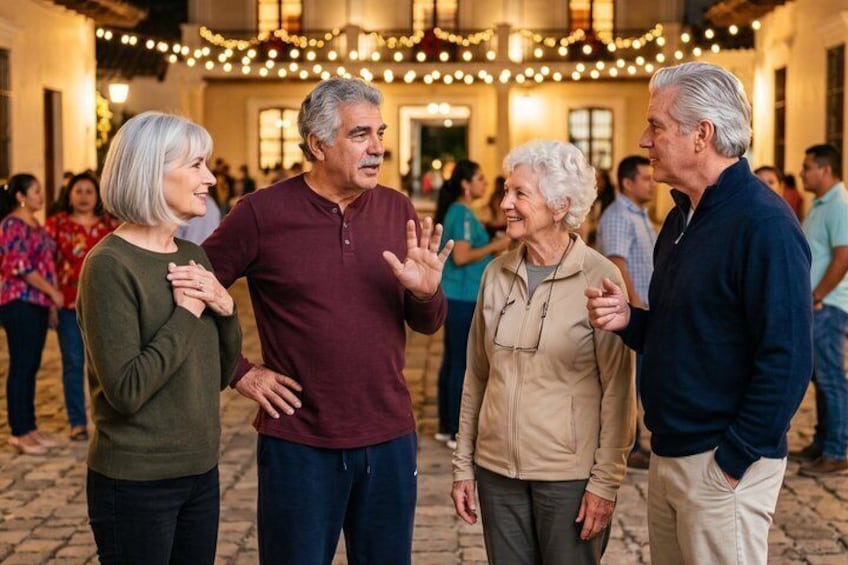 A group of people standing in a courtyard with string lights overhead. 3