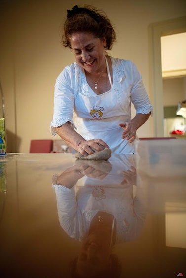 A person cleaning a glass table. 5