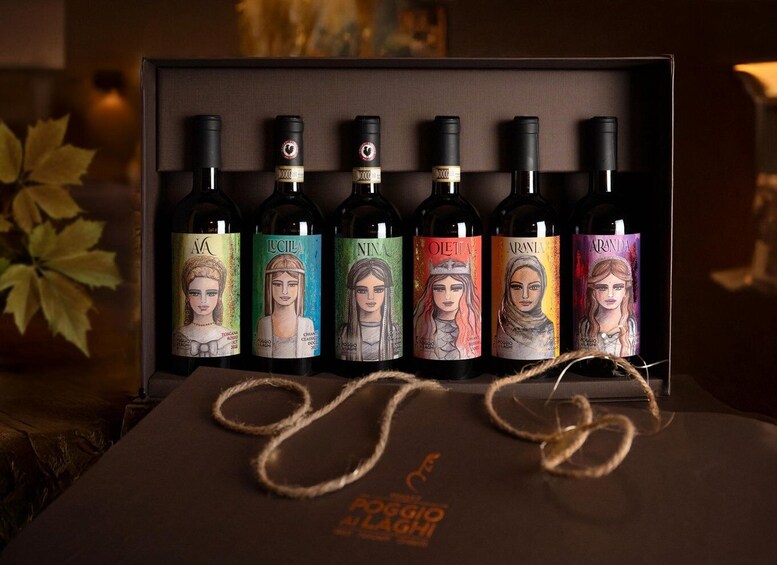 A collection of wine bottles with unique labels, arranged in a box. 2