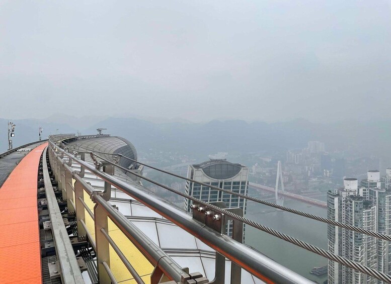 A high vantage point overlooking a city with a prominent bridge and modern buildings. 5