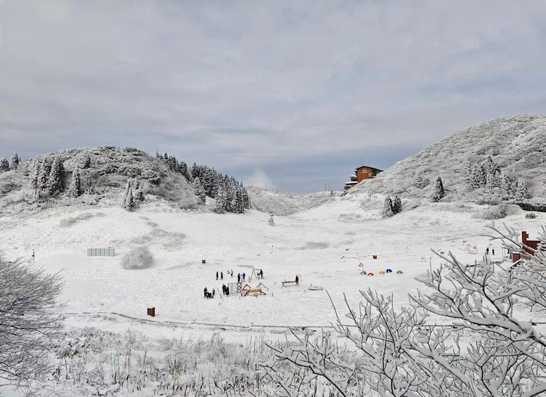 A snowy mountain landscape with a ski resort, including ski lifts and a lodge. 4