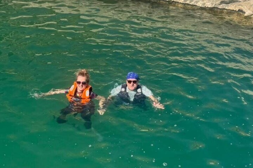 Two people swimming in clear water. 3