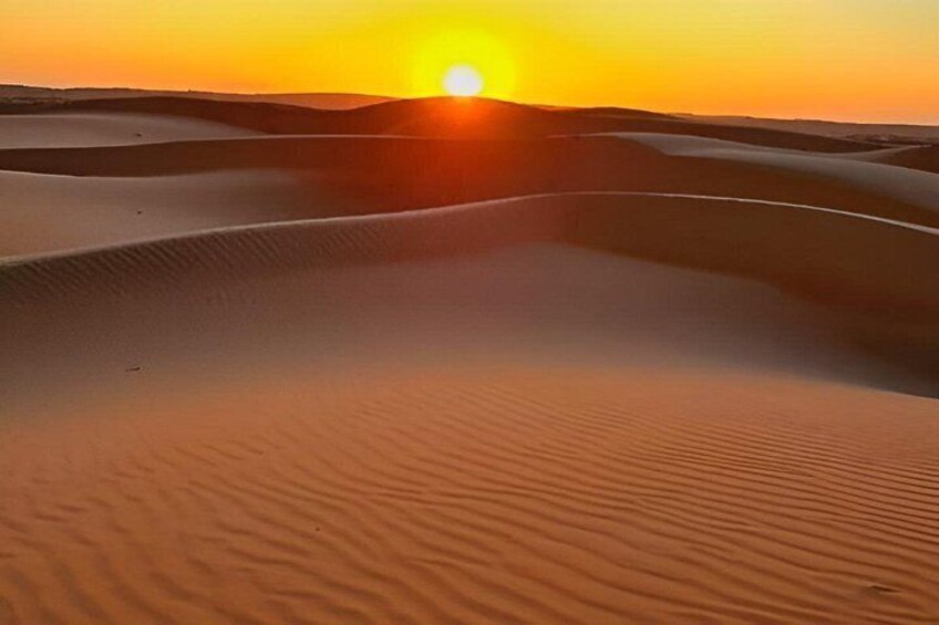Sand dunes with a sunset in the background. 4